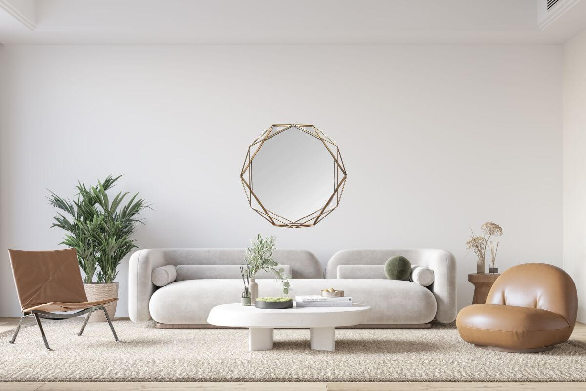 Octagon-shaped mirror above sofa