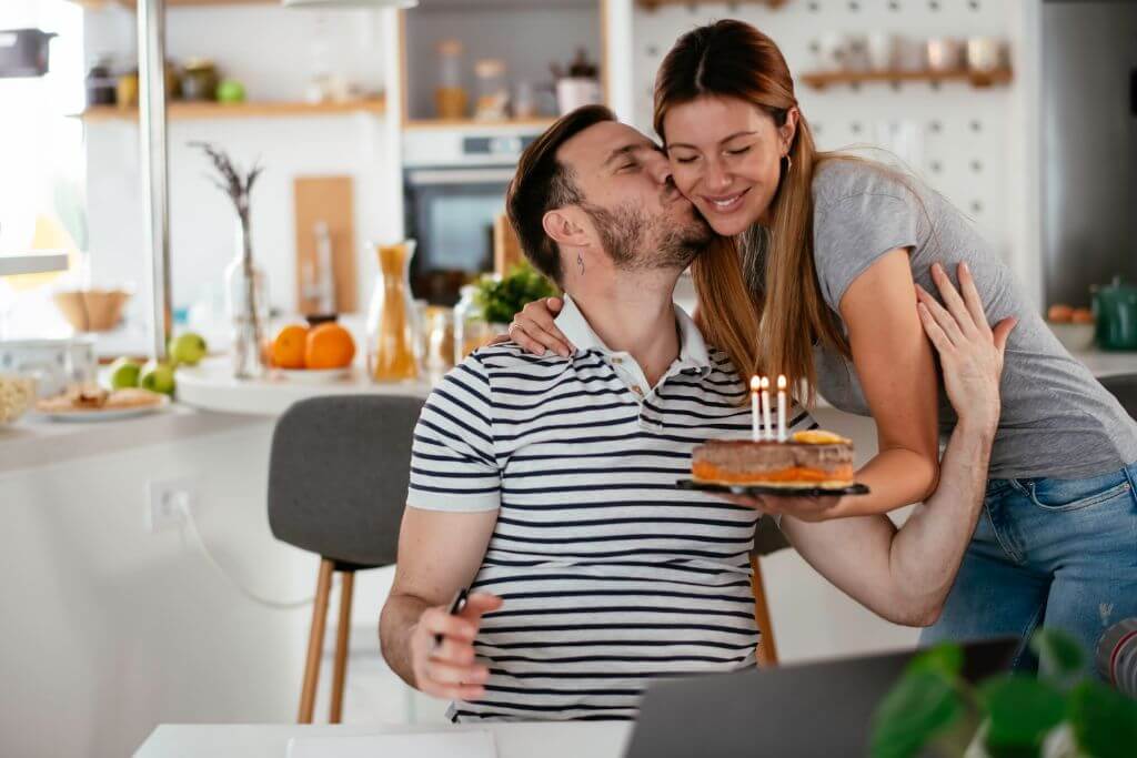 Woman giving husband a cake