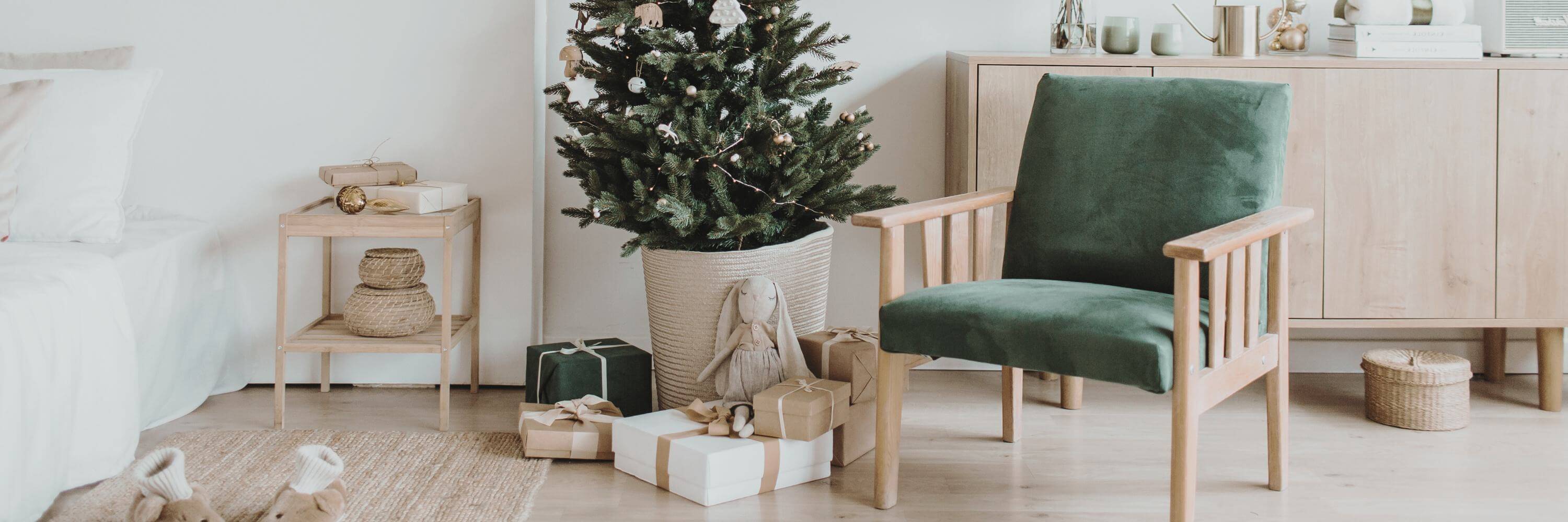 Christmas tree as seasonal decor next to a green armchair