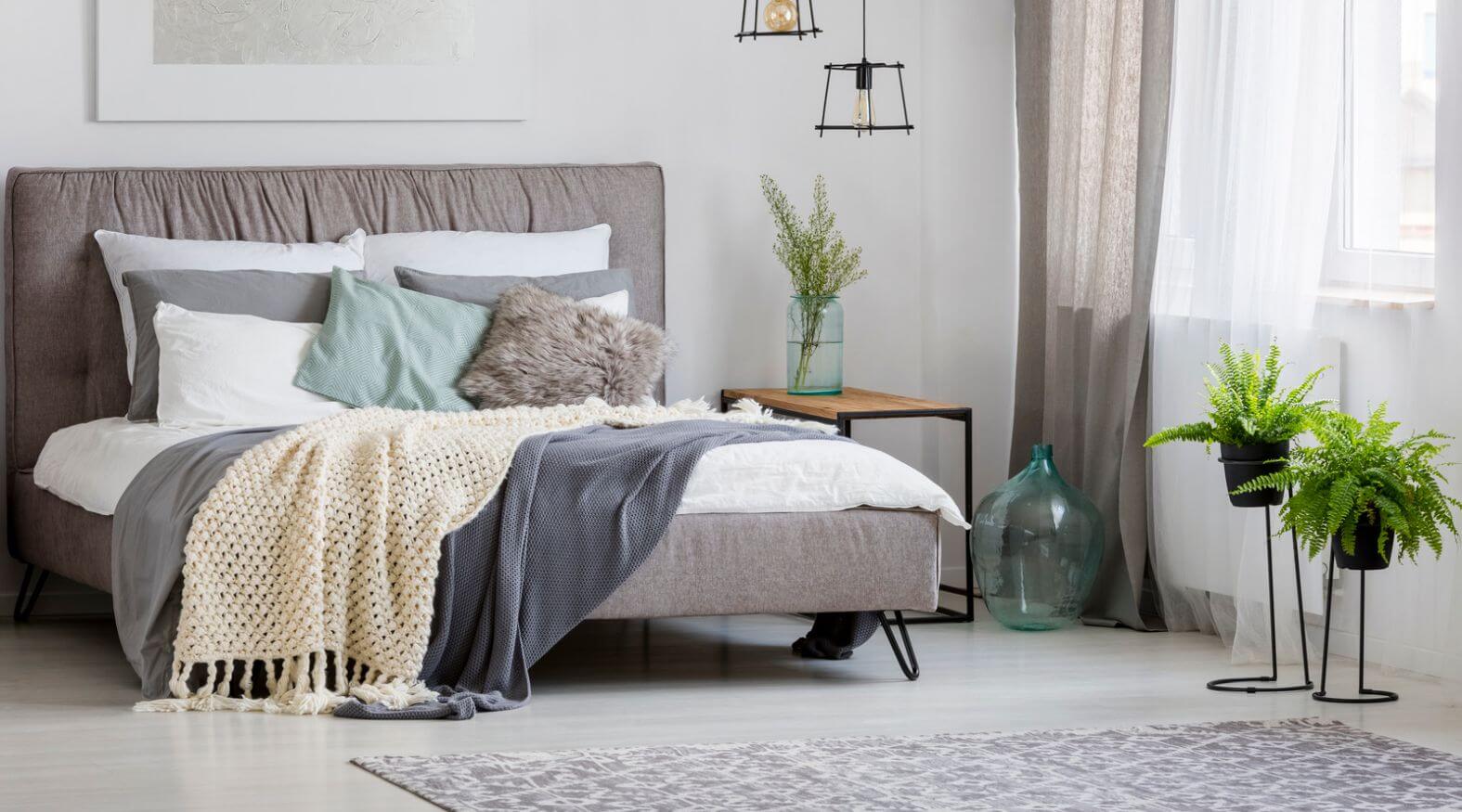 Gray bedroom filled with greenery