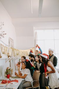 Colleagues enjoying a festive Christmas party in the office, celebrating with holiday decor and joyful expressions.