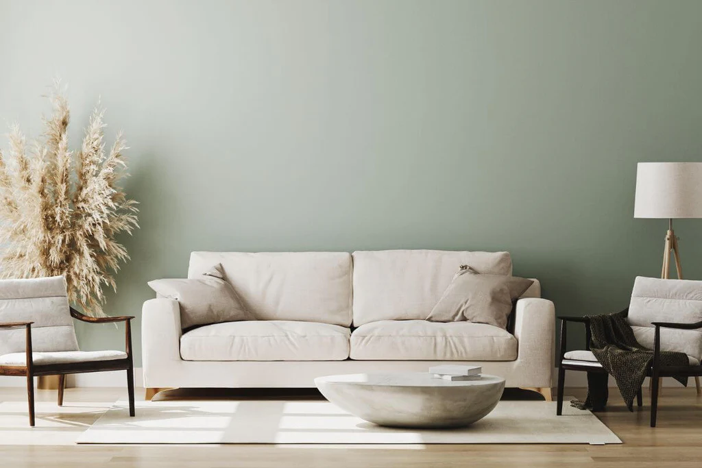 Pastel living room with mint green walls and beige sofa