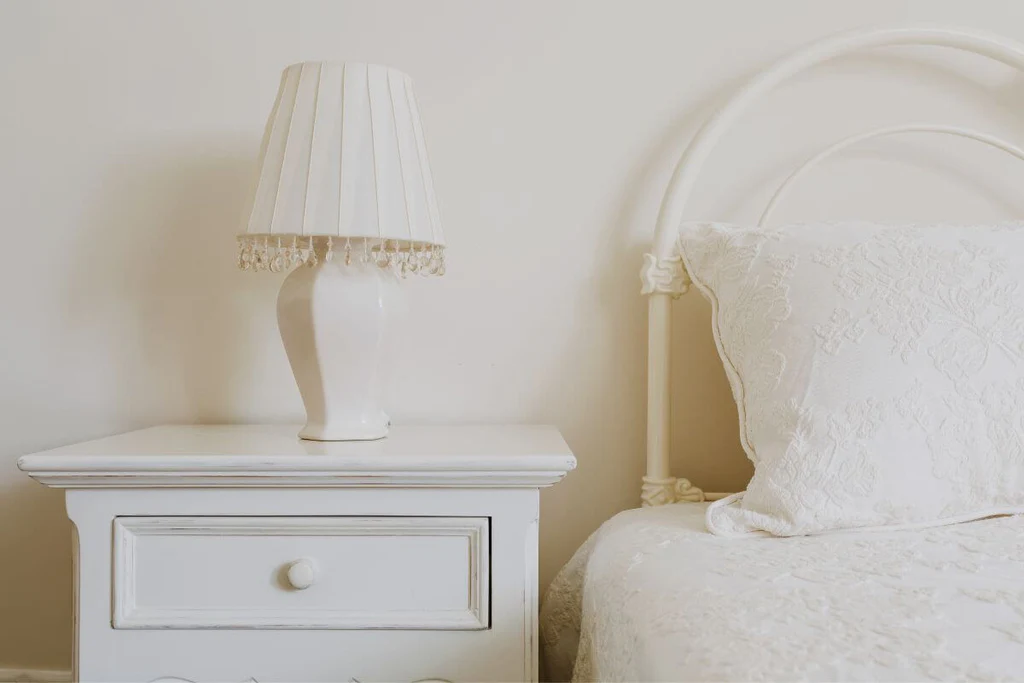 A white lamp as a focal point on the nightstand