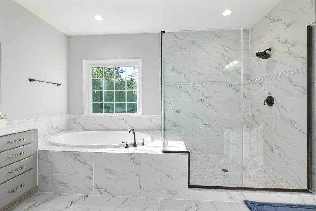 Frameless shower in minimal grey bathroom