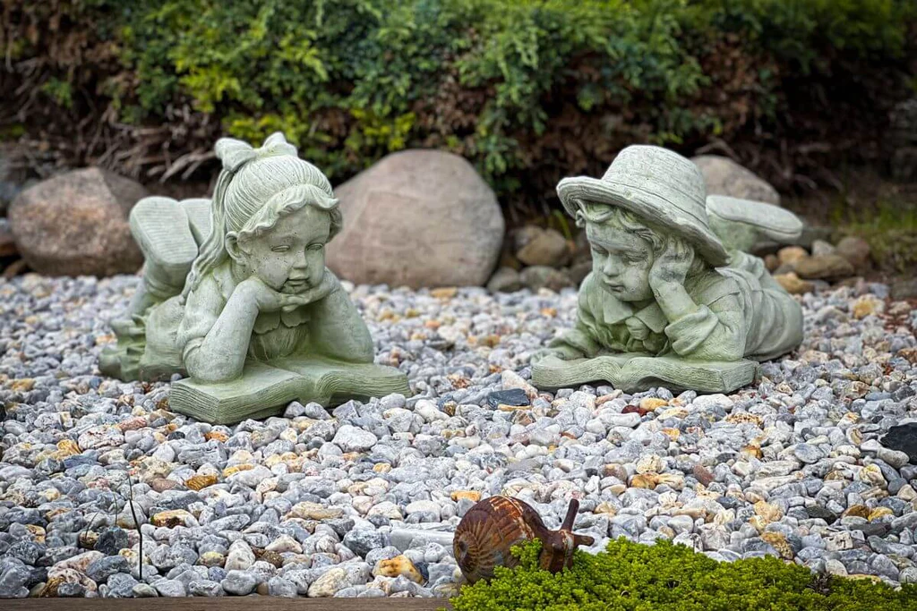Sculptures of a boy and a girl in the garden