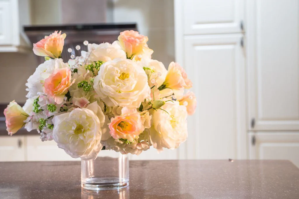 Flowers in a glass vase on the kitchen island