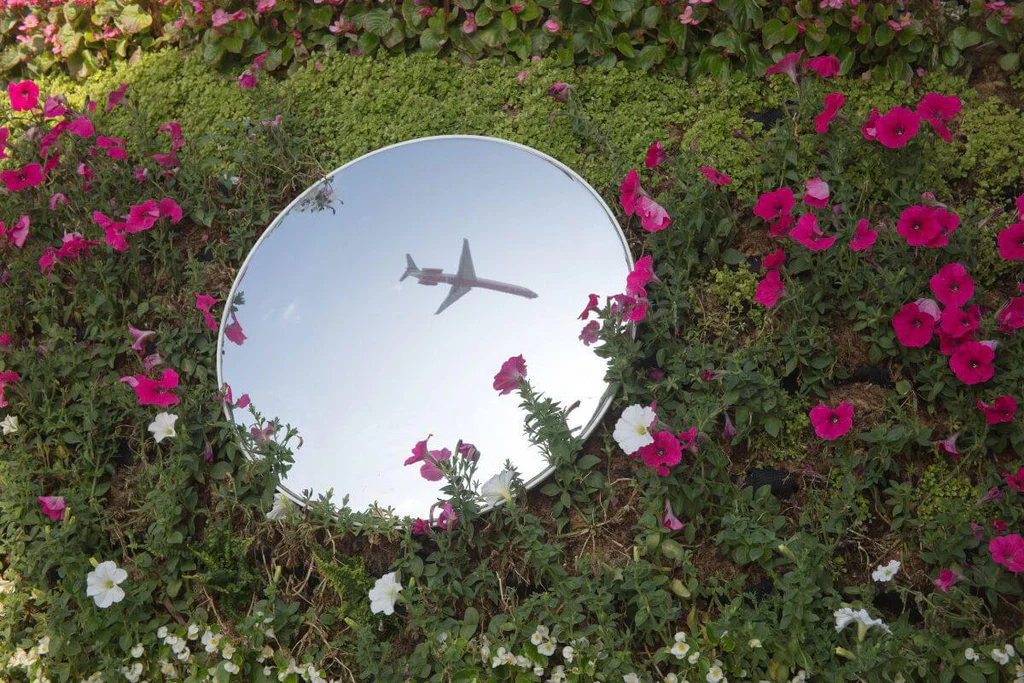Round mirror as desert garden decor