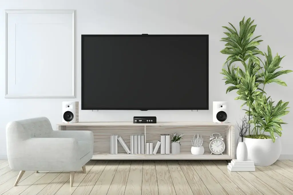 White TV stand with white book decor