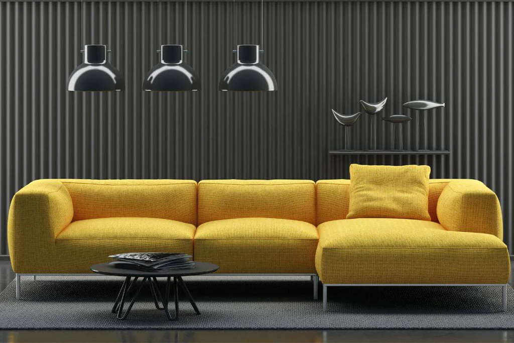 Black hanging lights above yellow sofa