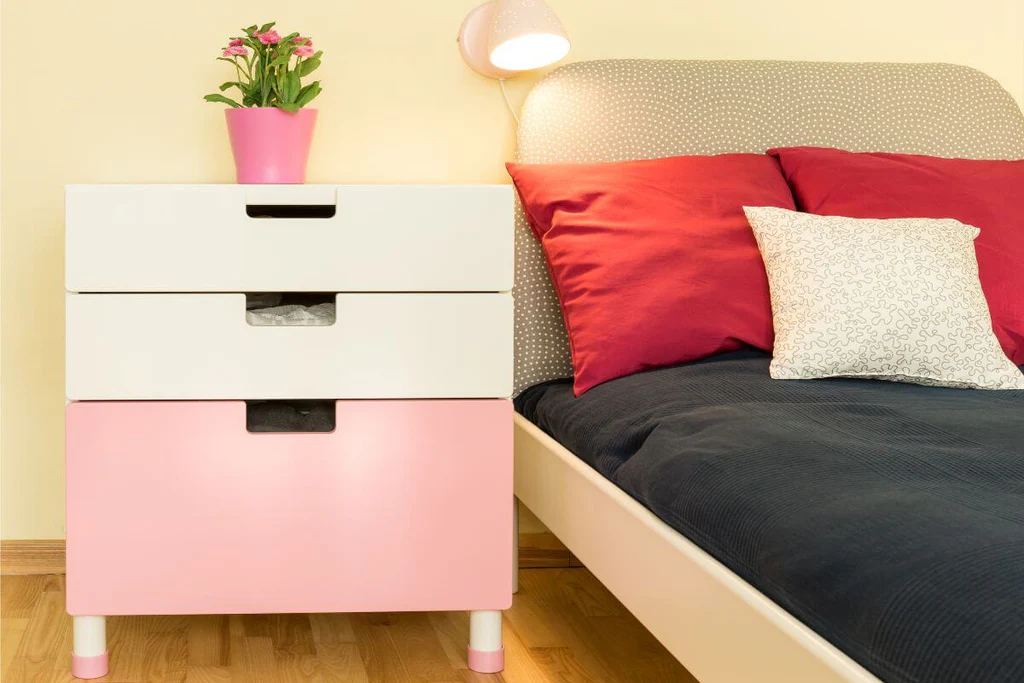 Pink and white nightstand with drawers