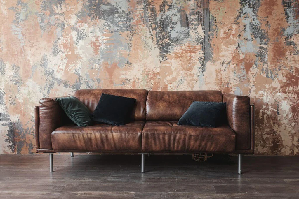 Abstract wallpaper behind brown sofa