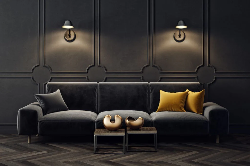 Black wooden panels behind black sofa