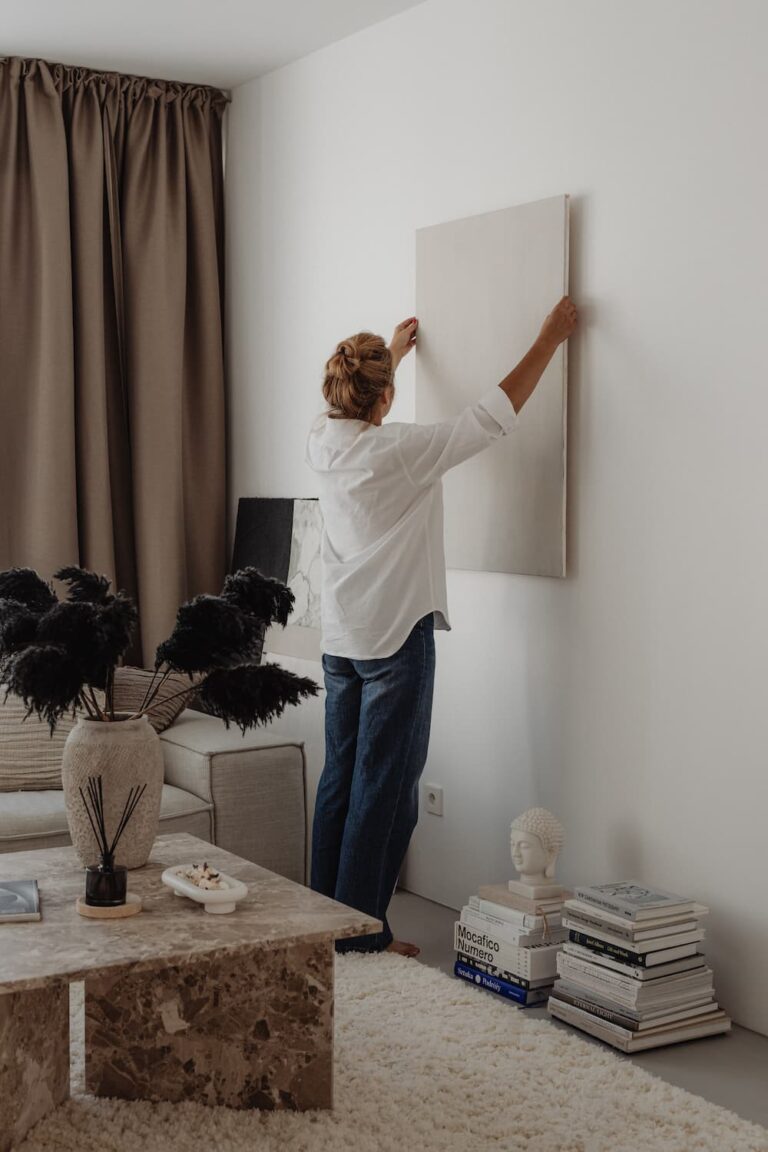 Woman putting canvas on the wall