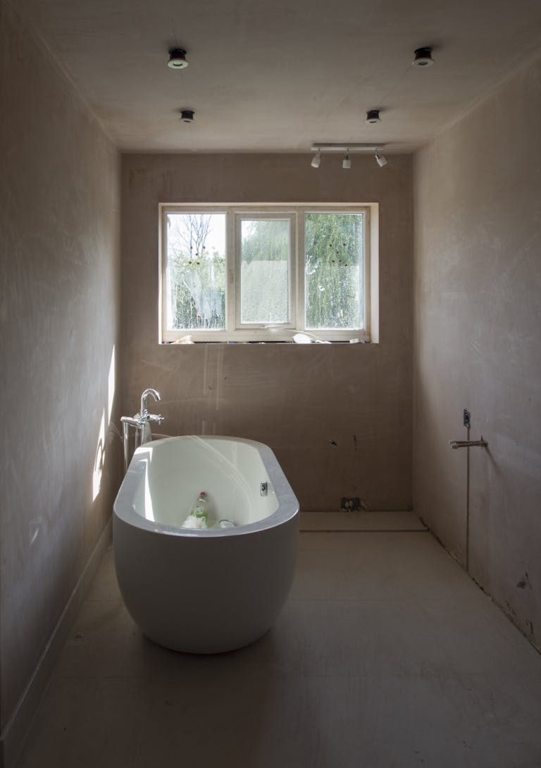 A bathroom with a large tub and window